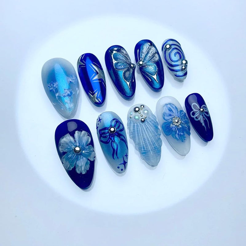 CJDLTS Flower Press on Nails Medium Almond Shaped Blue Artificial Acrylic Nails Gradient 3D Floral Butterfly with Bow Pearl Stick on Nails Full Cover Glue on Nail Artificial Fingernails for Women Manicure - Image 1